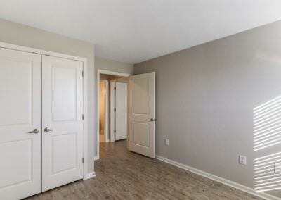 View of large walk-in closets and hallway from an apartment bedroom at Goodnight Commons