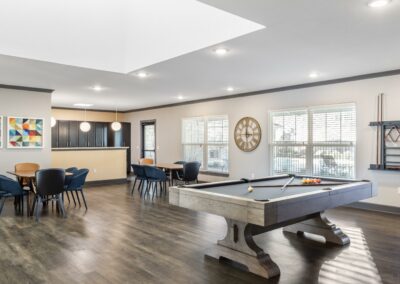 Resident lounge with seating area and pool table at Goodnight Commons