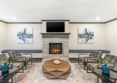 Community lounge room with comfortable couches, fireplace, and television at our Austin, TX apartment complex